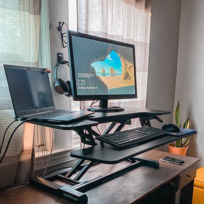 Reviewer standing desk converter in use on traditional desk