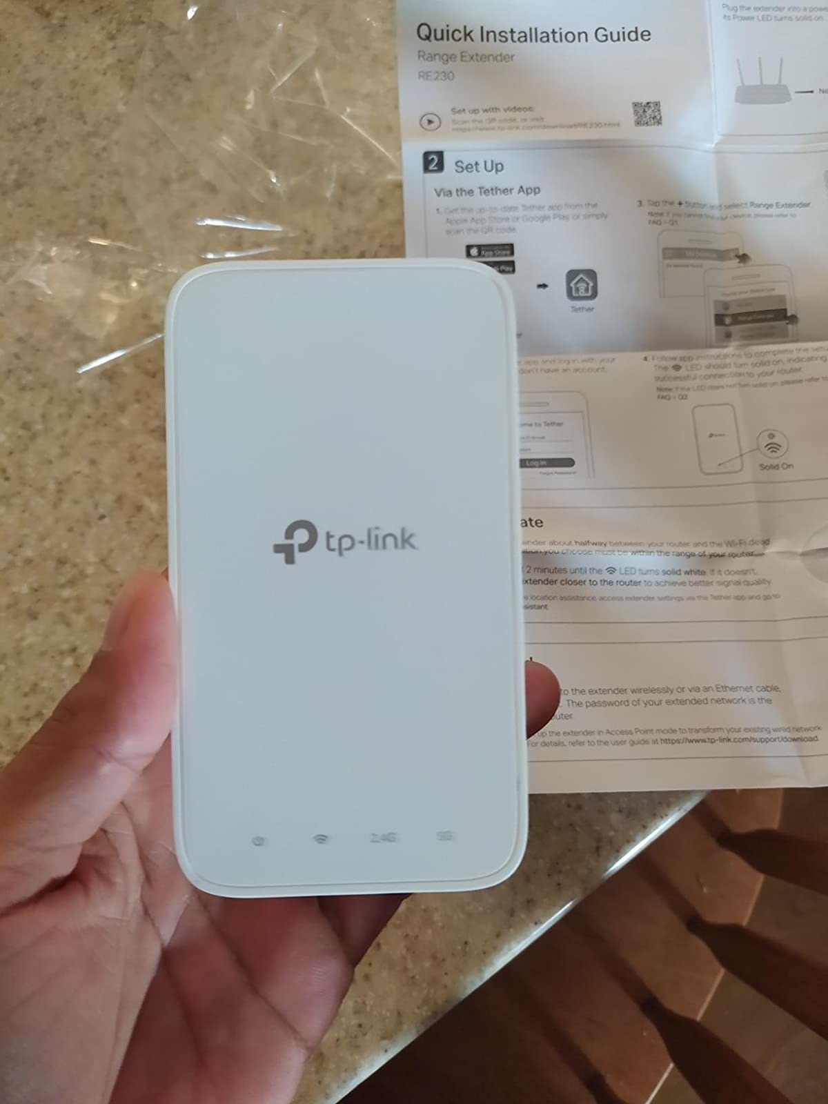 Reviewer with wifi extender in hand