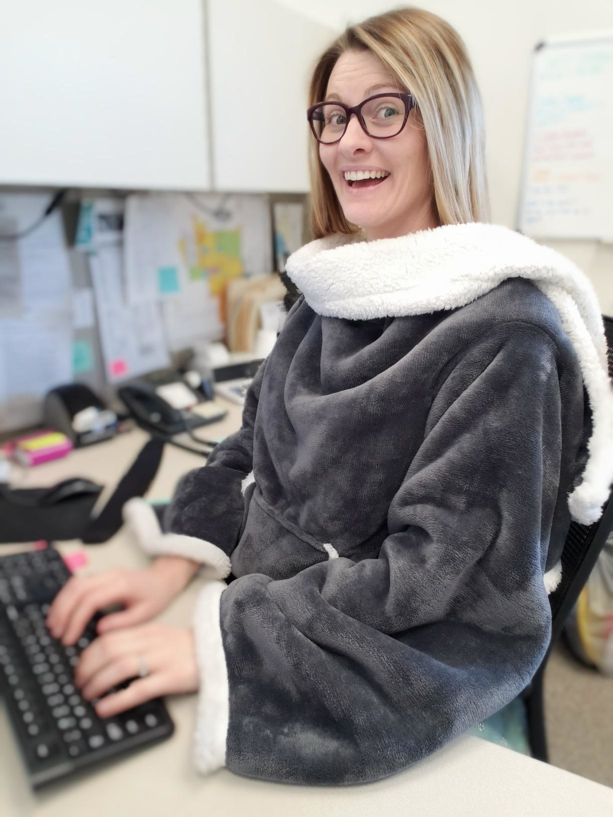 Reviewer wearing sherpa blanket at work
