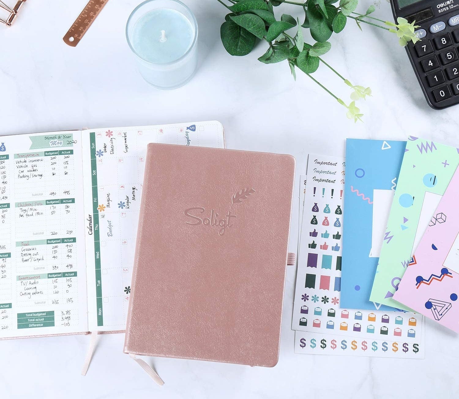 The budget planner closed, next to what it looks like open, along with a bunch of stickers