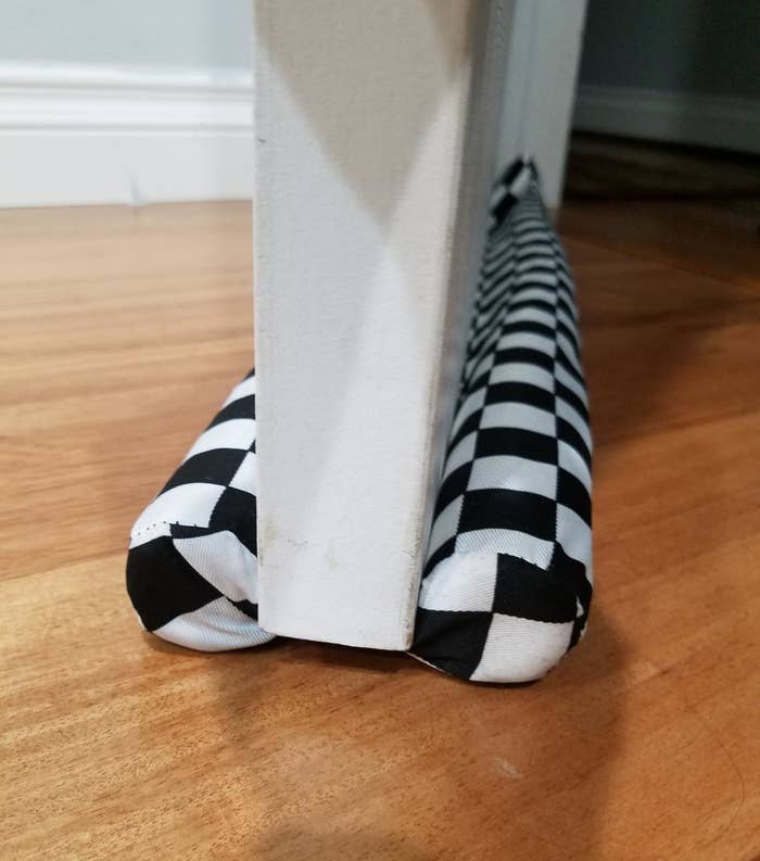 reviewer photo showing double door draft stopper in checkered print