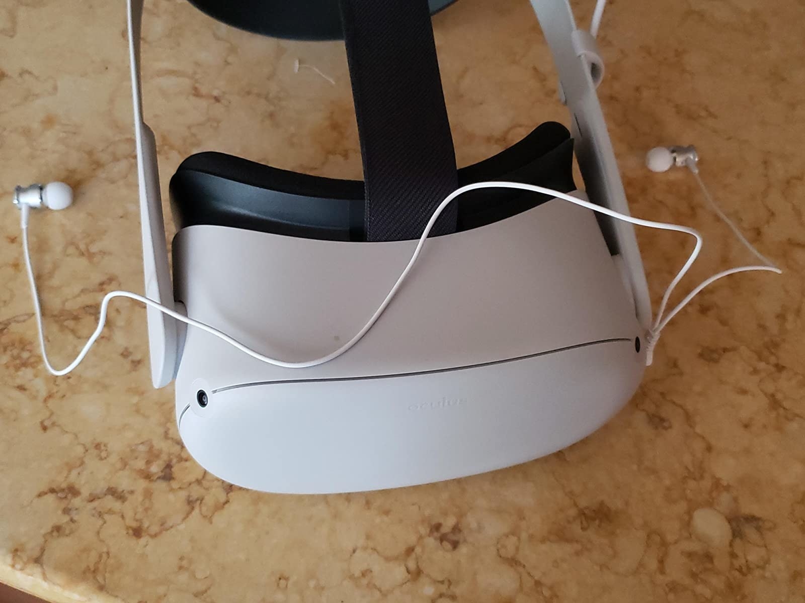The white earbuds on top of an Oculus Quest 2