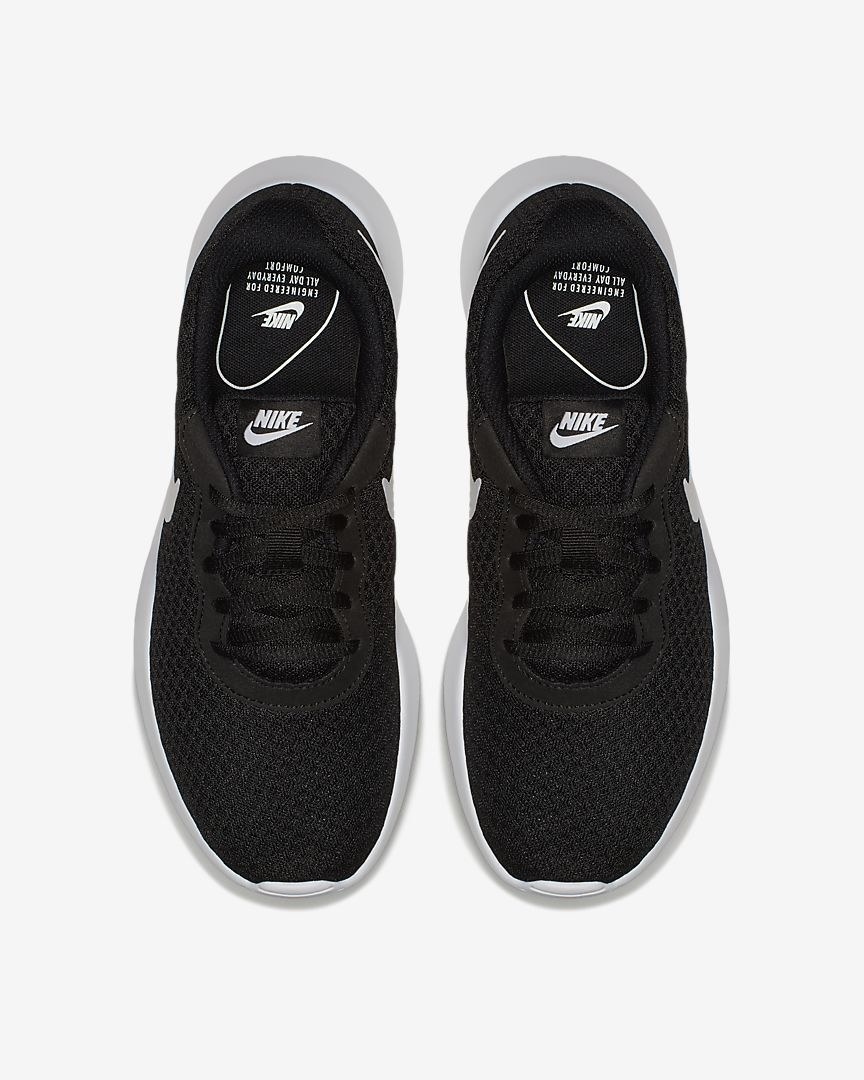 black sneakers with white accents and the nike swoop on the side