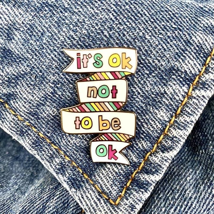 a pin that says &quot;it&#x27;s ok not to be ok&quot; in rainbow lettering 