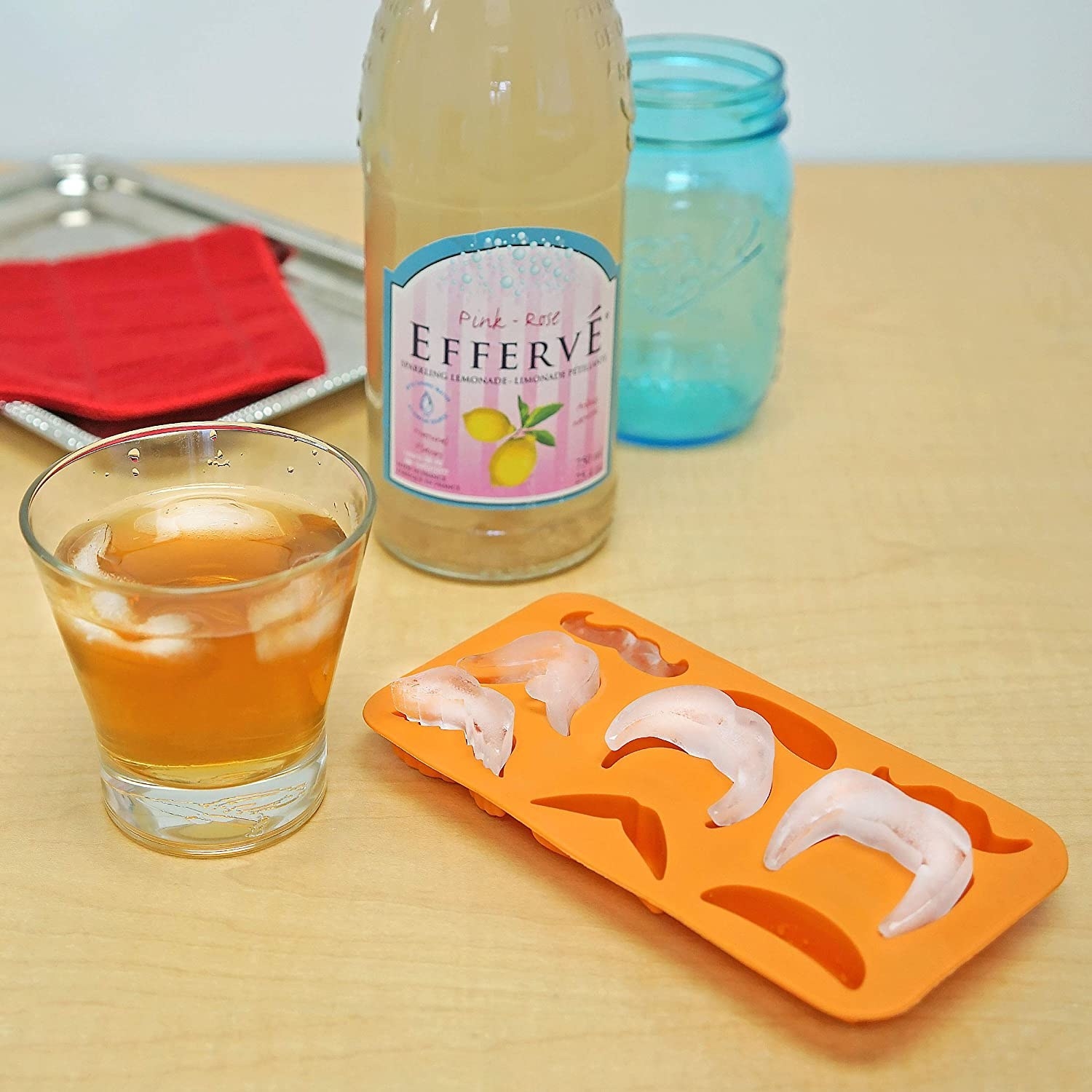 The ice cube tray filled with moustache-shaped cubes