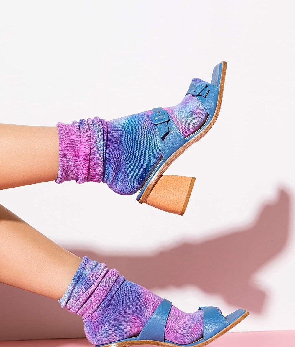 model wearing purple/pink tie-dye socks with heeled sandals