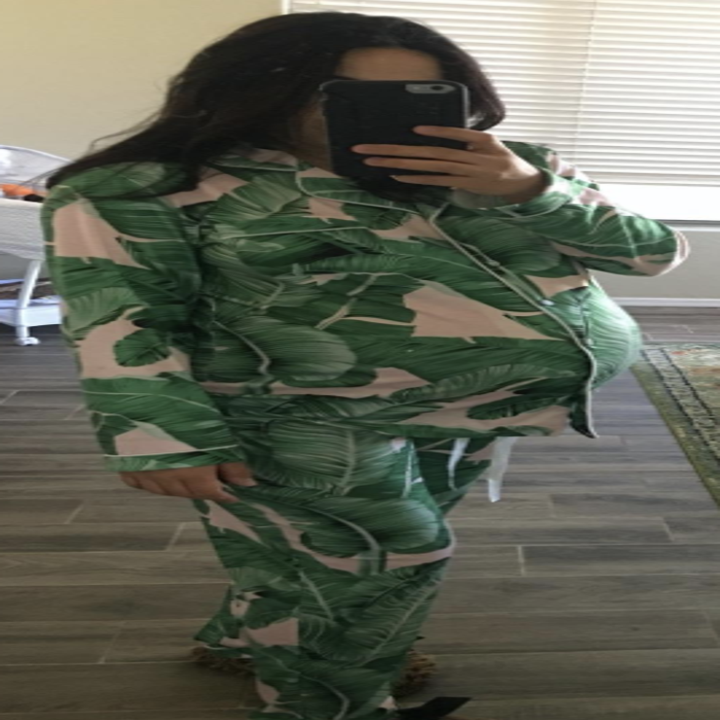 Reviewer wearing green leaf and pink pajama set