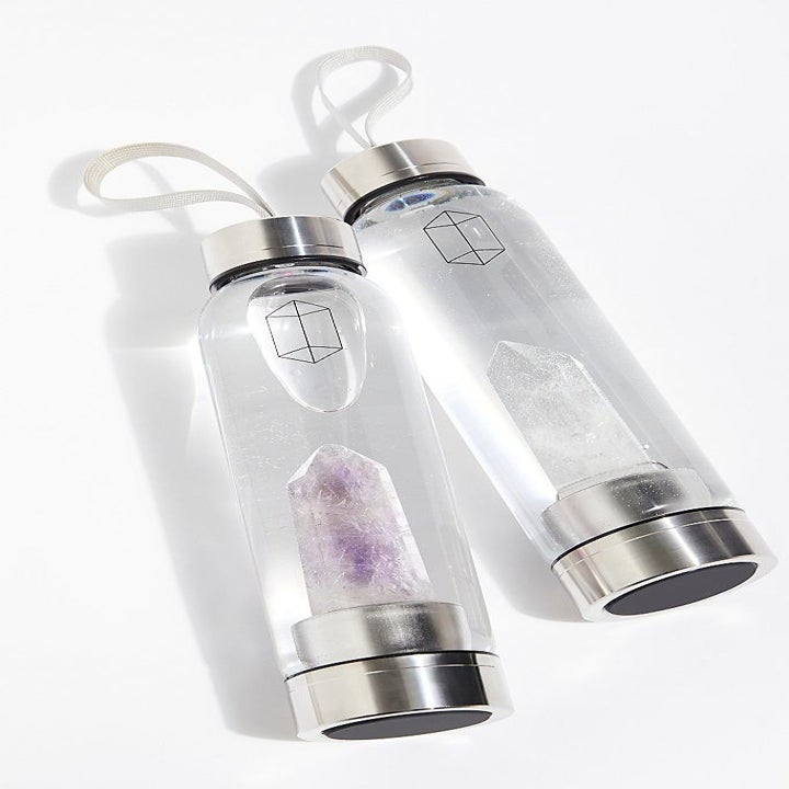 two glacce crystal elixir water bottles next to one another 
