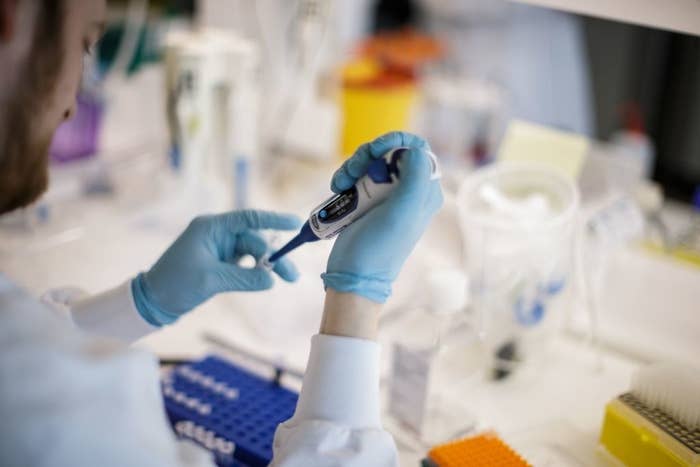 A scientist working in a laboratory on a vaccine. 