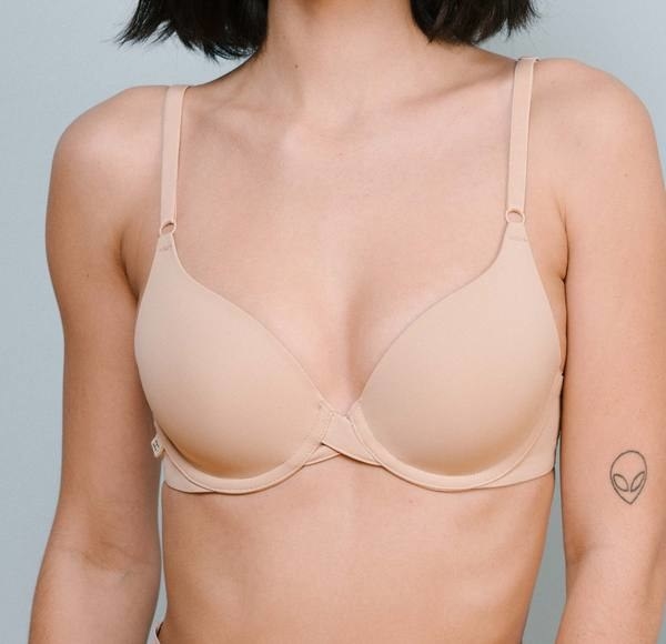a model wearing a beige bra