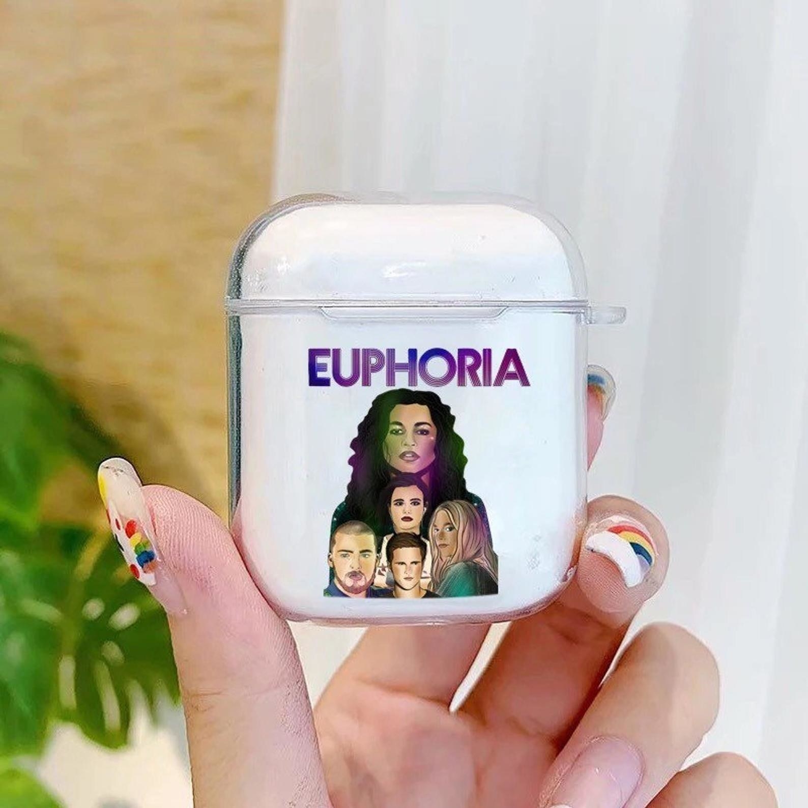 a hand holds up the euphoria inspired airpods case
