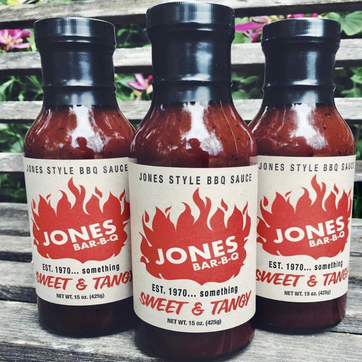 A close-up of three bottles of Jones BBQ's sauce