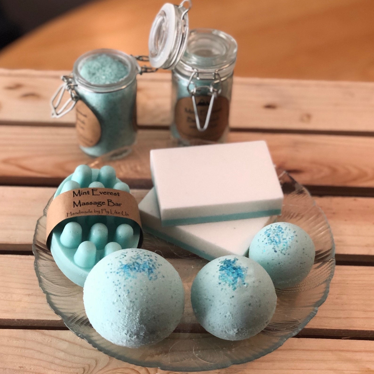 The different styles of soaps and bath bombs in a light blue color 