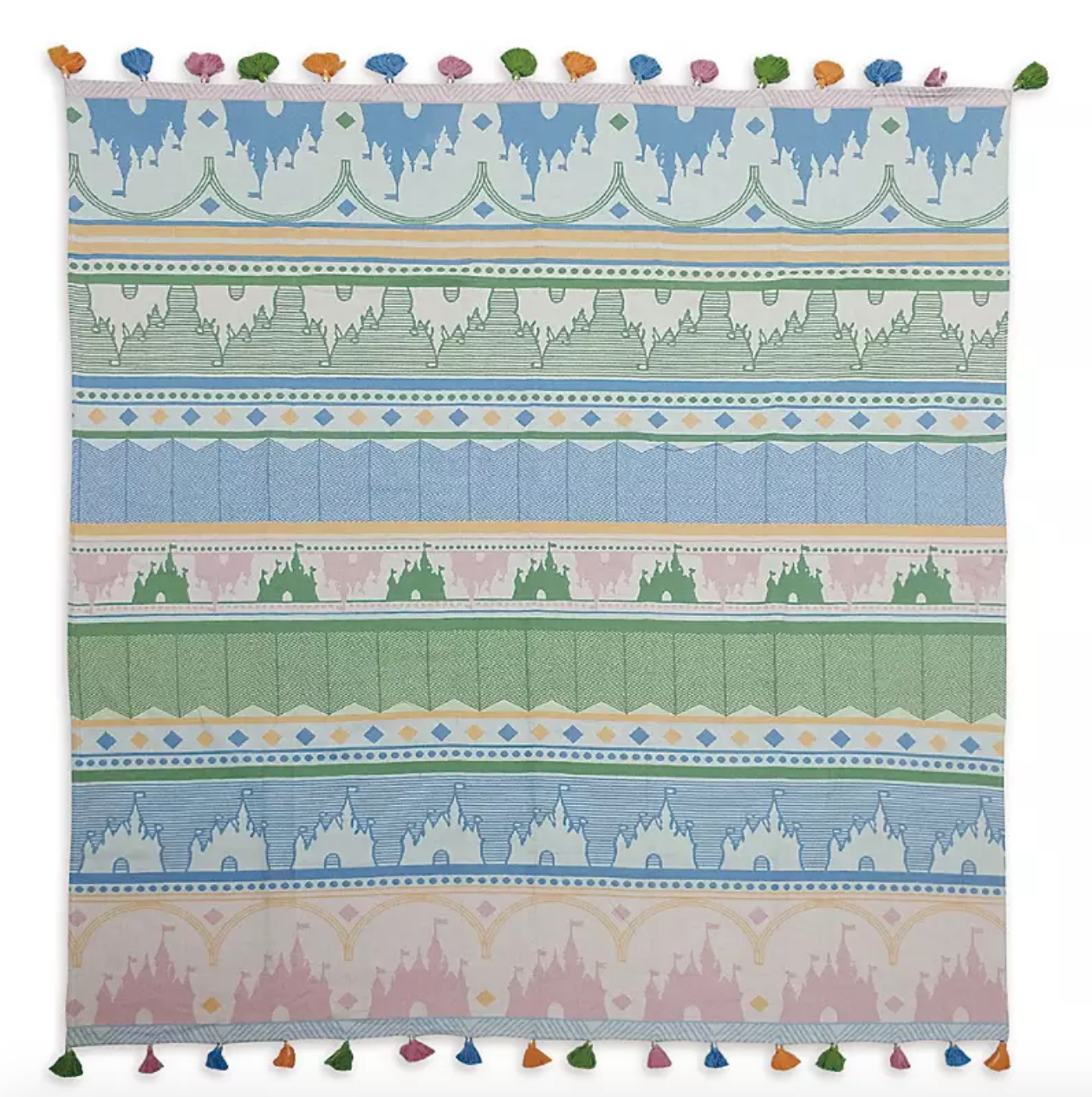 a throw blanket with a design of castles on it and colored tassels on the edges