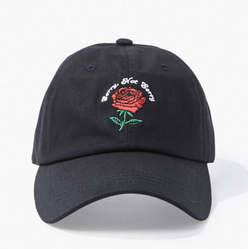 A black dad hat with an embroidered rose and the words &quot;sorry not sorry&quot; 