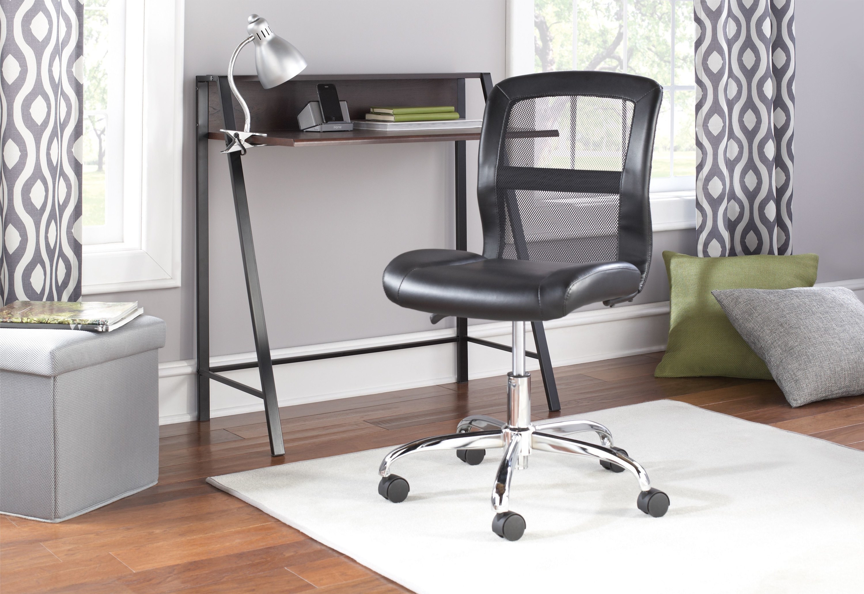 black rolling office chair in front of a writing desk