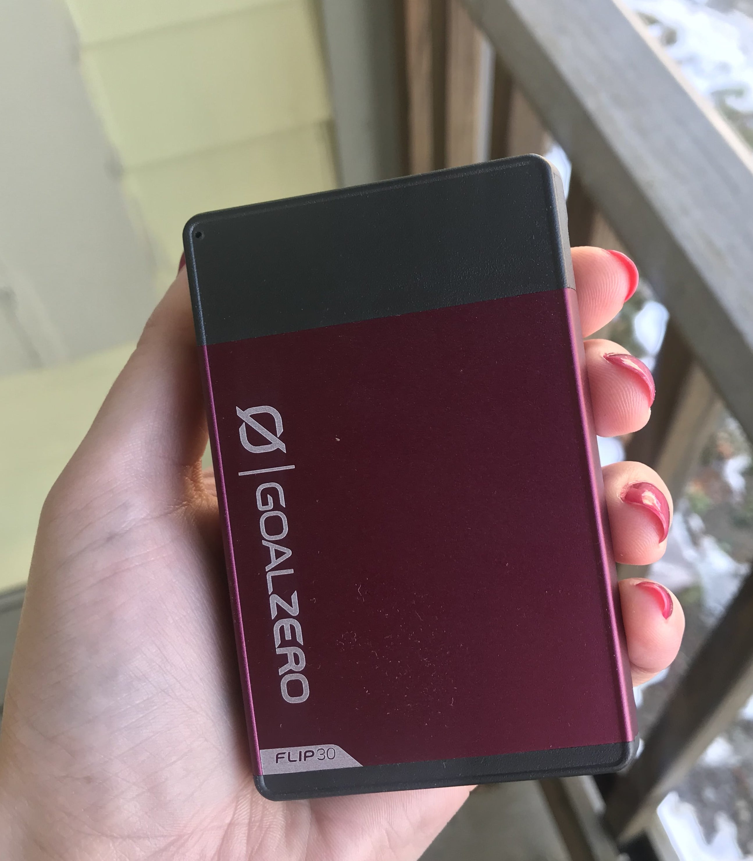 writer holding pink power bank