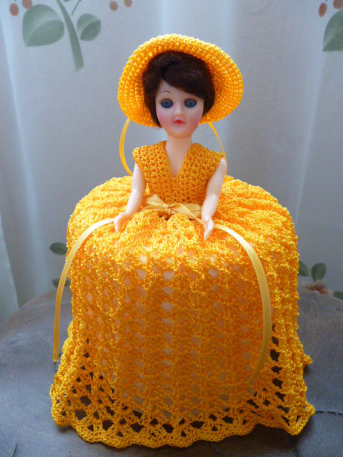 A toilet paper doll with a knit dress to cover the roll