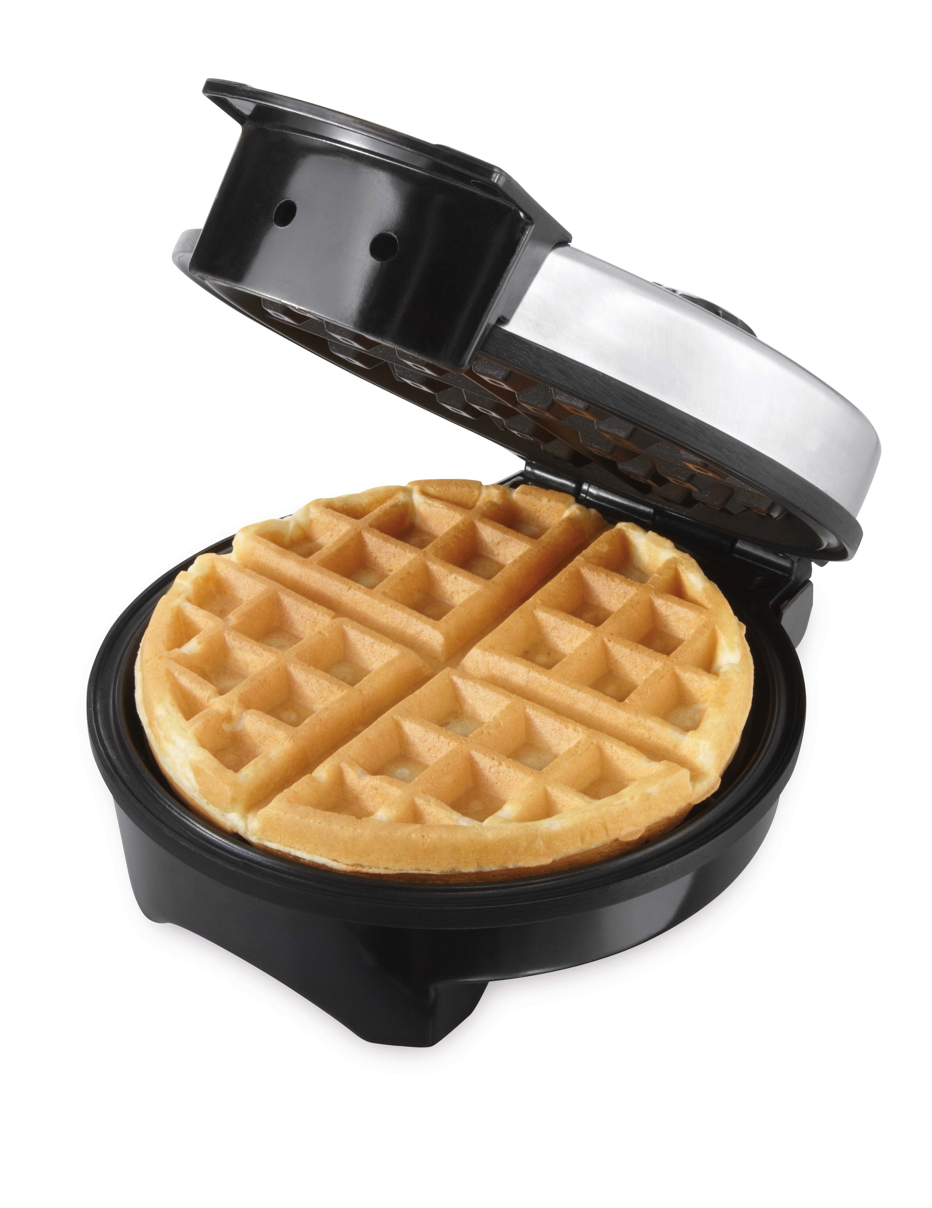 oster waffle maker open and revealing a perfectly crisped waffle