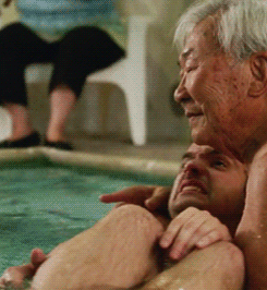 Tran carrying and spinning Nick in a pool
