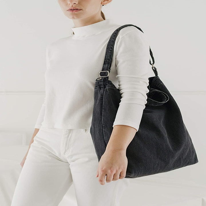 A model carrying the washed black version over their shoulder