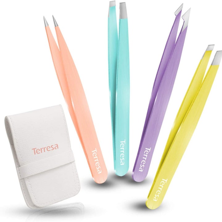 Pink, blue, yellow, and purple tweezers that say "Terresa" on the side