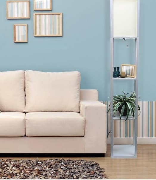 The lamp, which has an open rectangular base with three shelves, topped with a rectangular light