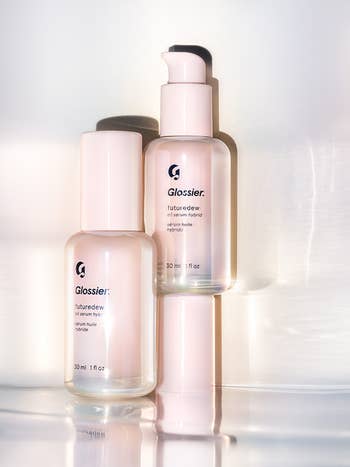 Pink and clear bottles of Glossier's Futuredew hybrid serum