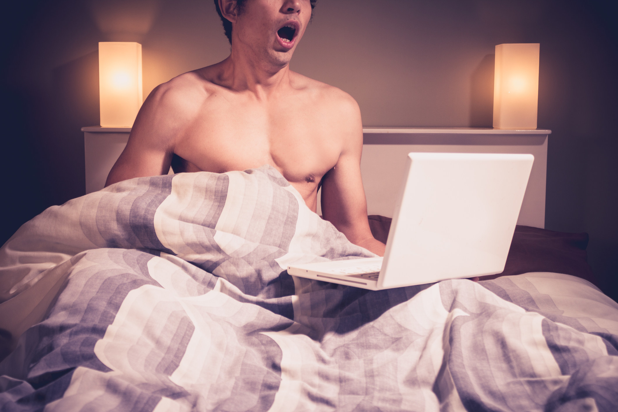 A man in bed with a laptop