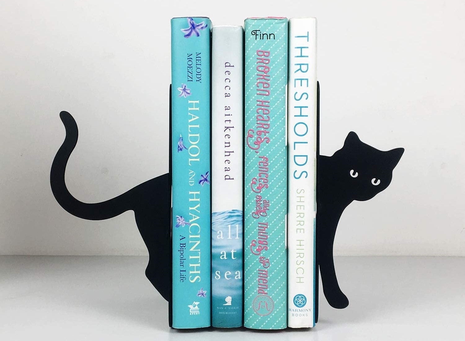 black cat book ends with books held between