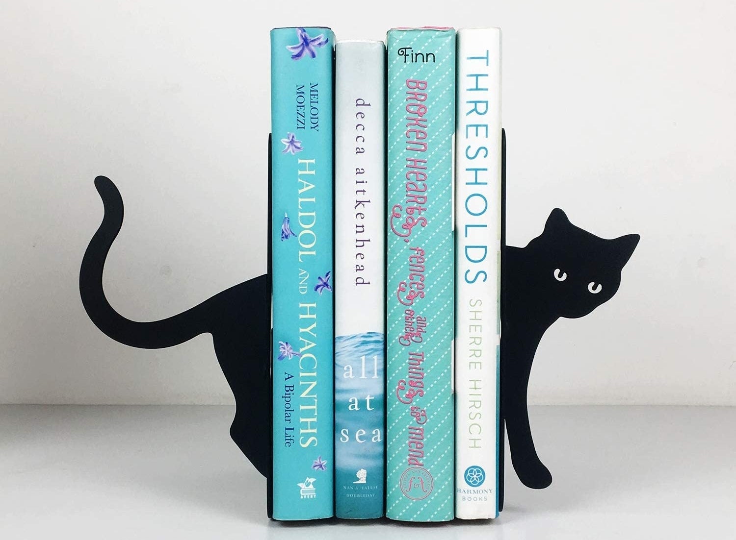 black cat book ends with books held between 