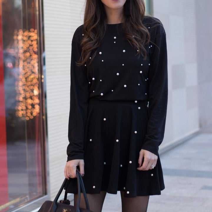 black sweatshirt with pearls all over chest
