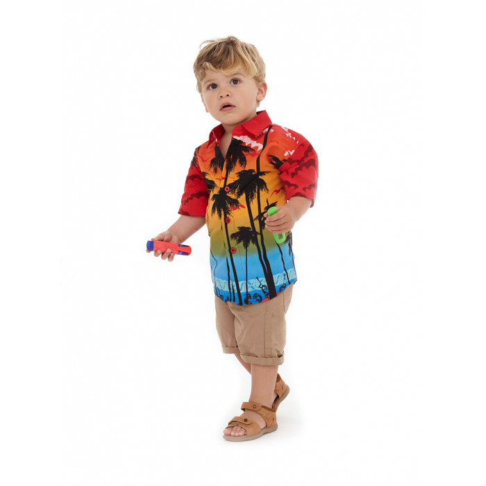 Toddler in a collared shirt that depicts a sunset against palm tree silhouettes
