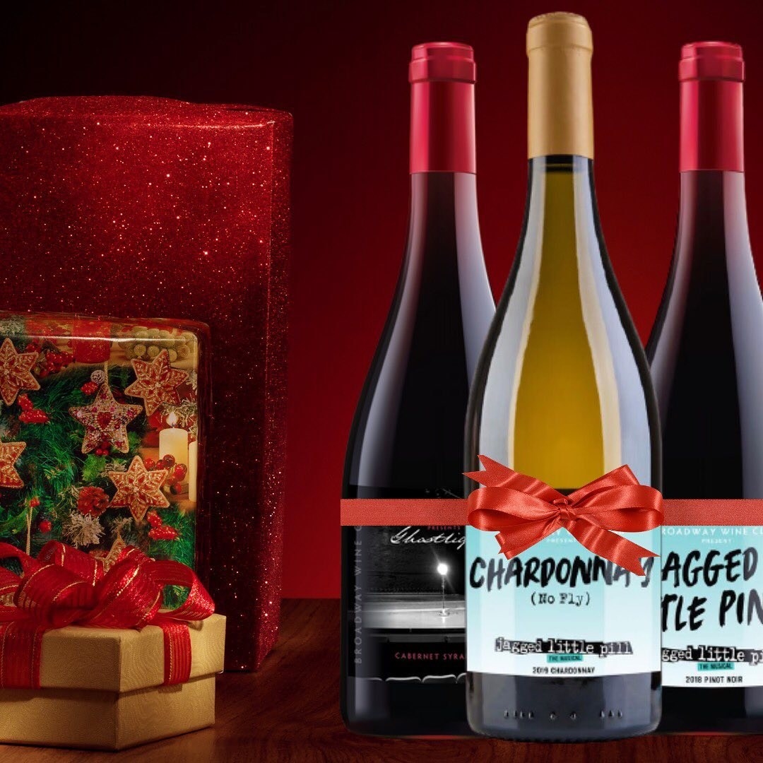 Three bottles of wine with bows on them and specific Broadway-themed labels