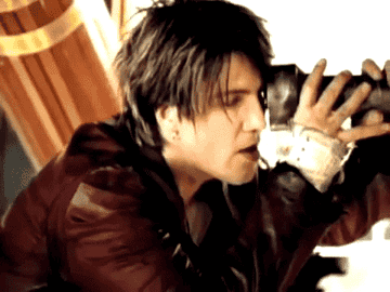 GIF of John Rzeznik looking through a telescope in the Iris music video