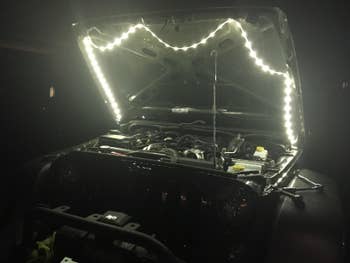 Reviewer with Luminoodle lights attached to the hood of their car
