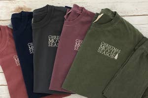an array of sweatshirts that say "christmas movie season" on them