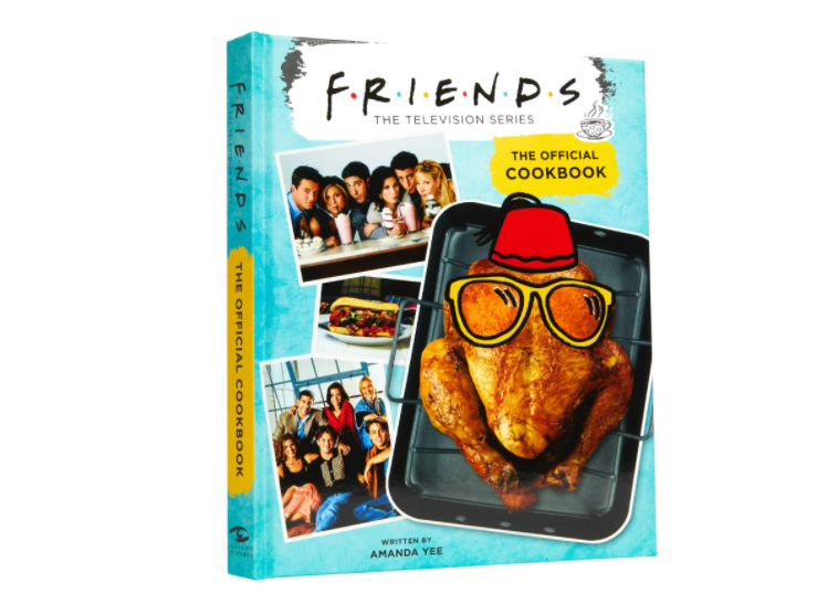 The Friends cookbook which features two photos of the cast a giant baked turkey on a roasting pan wearing a cartoon cartoon glasses and a red fez