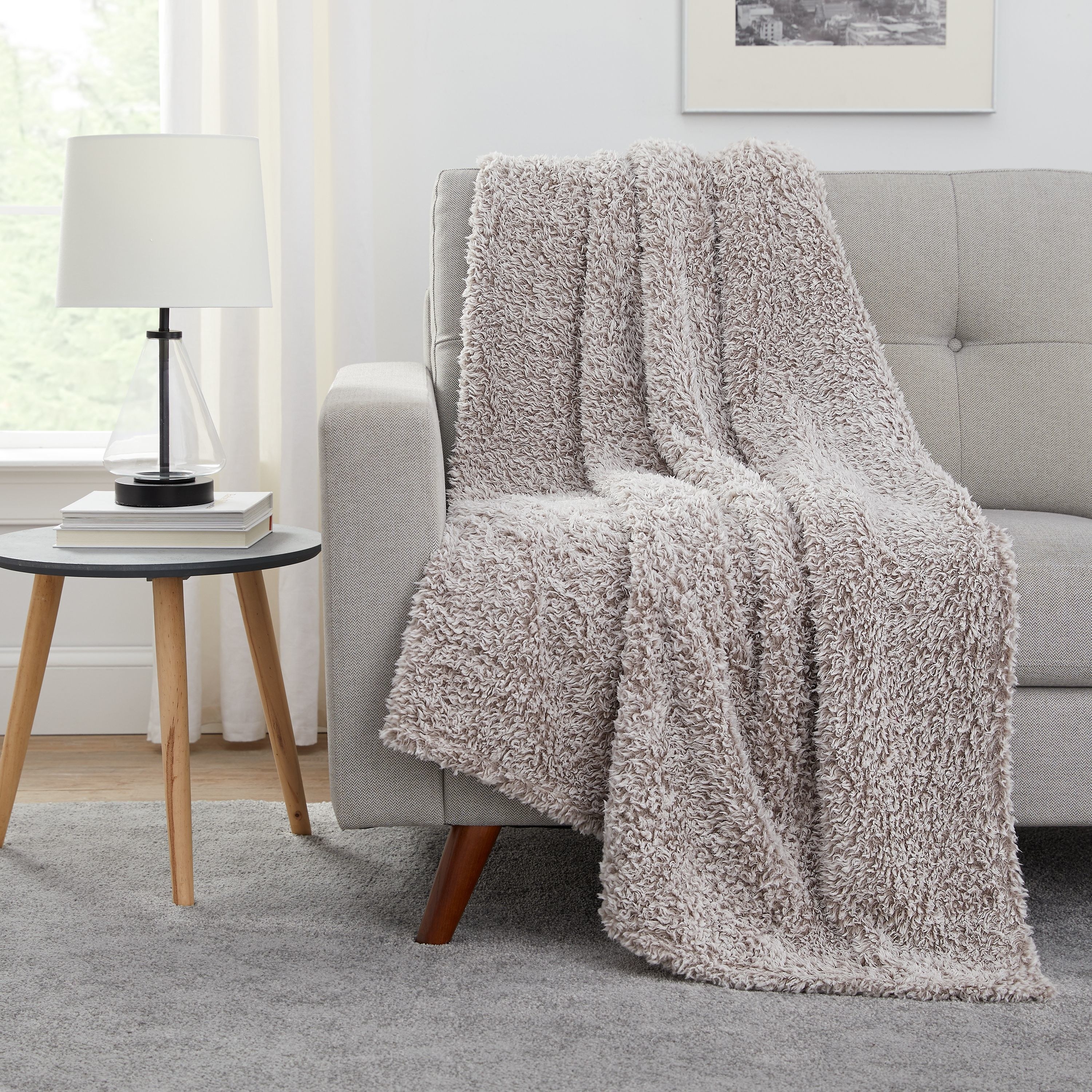 taupe sherpa throw blanket draped on a chair