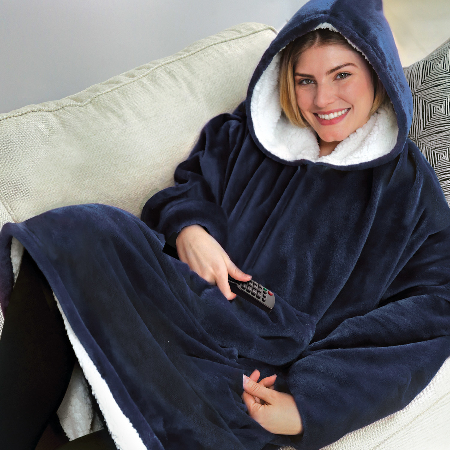 woman wearing a navy hoodie blanket sitting on a couch