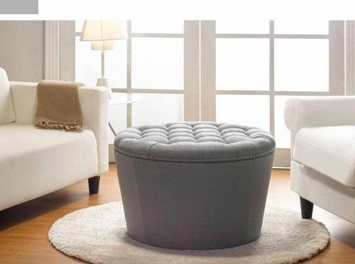 gray round ottoman with tufted top in a living room