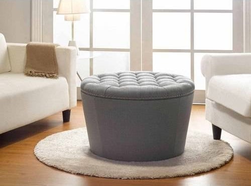 gray round ottoman with tufted top in a living room
