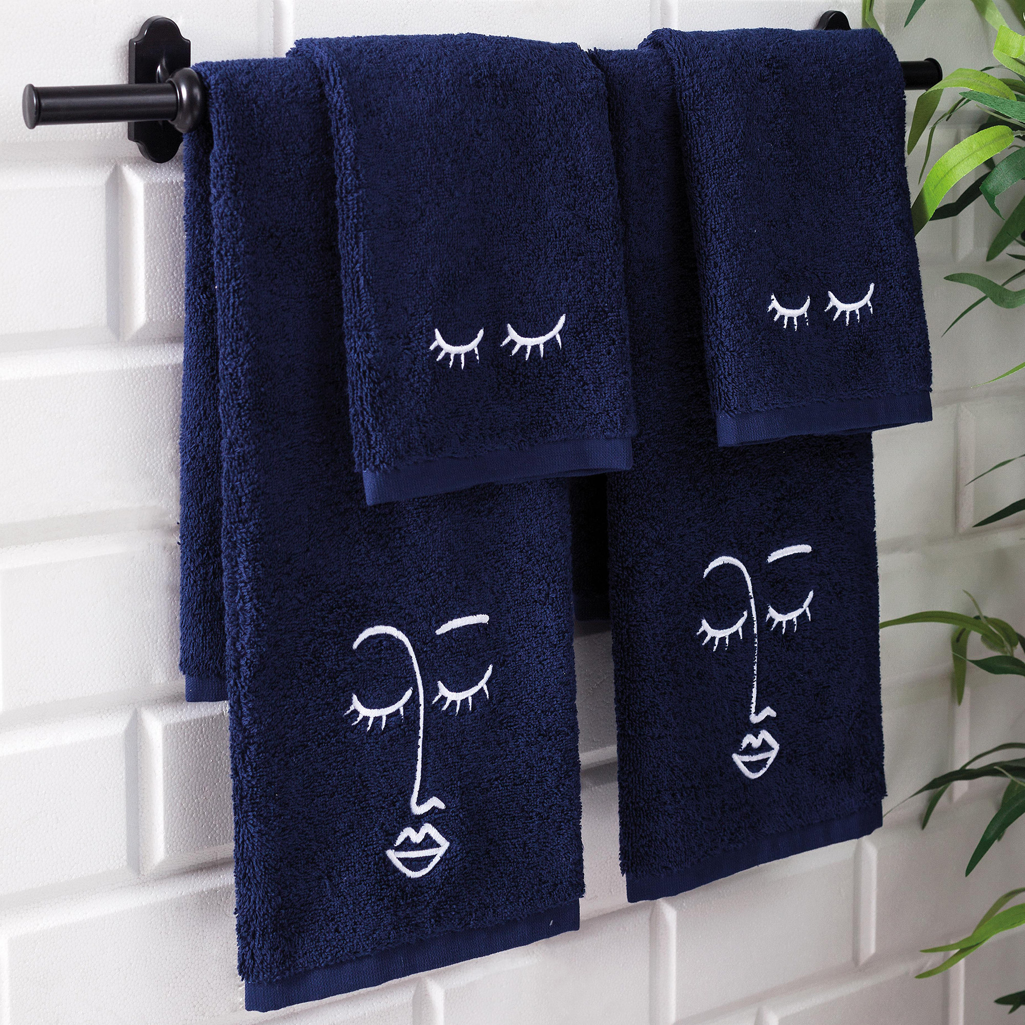 navy blue makeup and face towels with white eyelash and face outline design