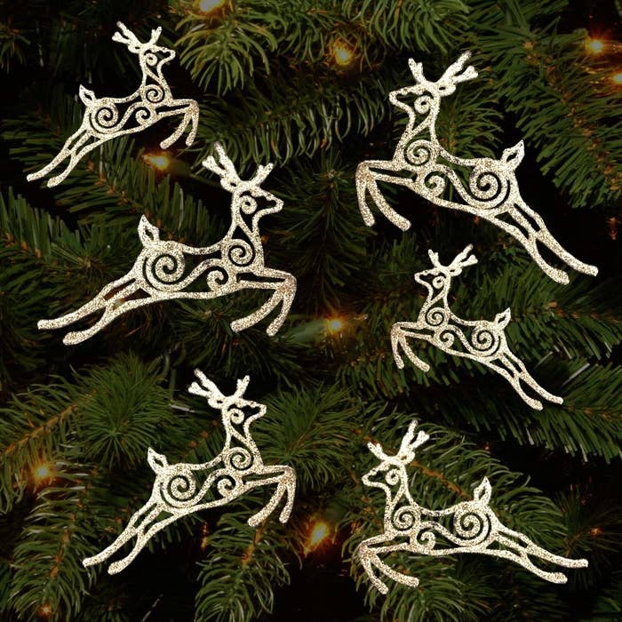 Six galloping reindeer ornaments covered in silver glitter.