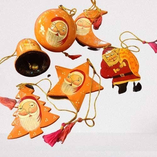 A set of six orange-coloured ornaments shaped like a bauble, a Christmas tree, a star, the moon, a bell and a Santa with his sack - with a Santa painted on each of them.