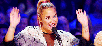 Demi dancing and raising her arms
