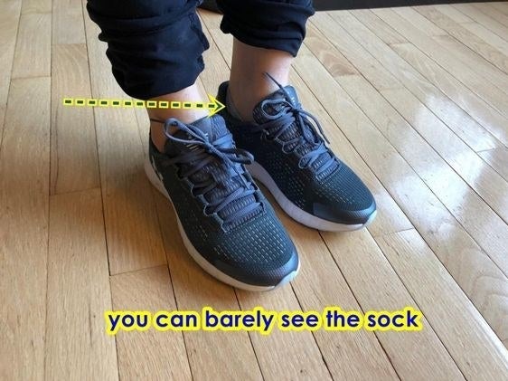 Reviewer wearing sneakers to show how the sock stays hidden 