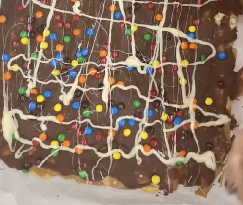 Melted chocolate covered with M&amp;amp;Ms and drizzled white chocolate