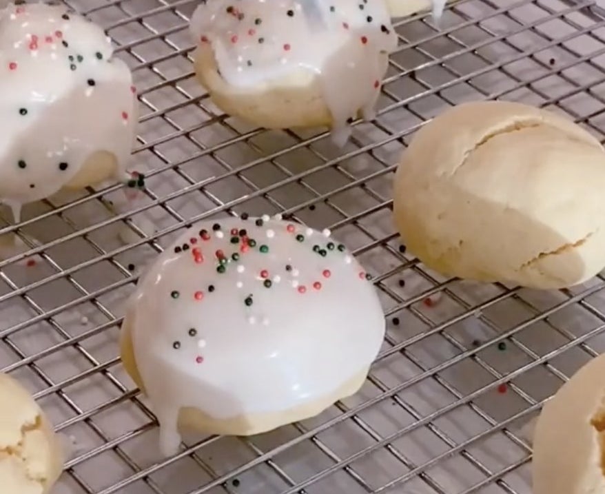 Small cookies with white frosting and red green and white sprinkles 
