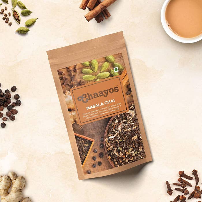 Packet of Chaayos masala chai on a table surrounded by spices